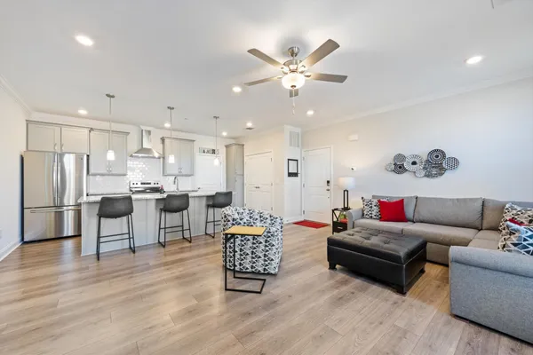 a kitchen with kitchen island a stove a table and chairs in it
