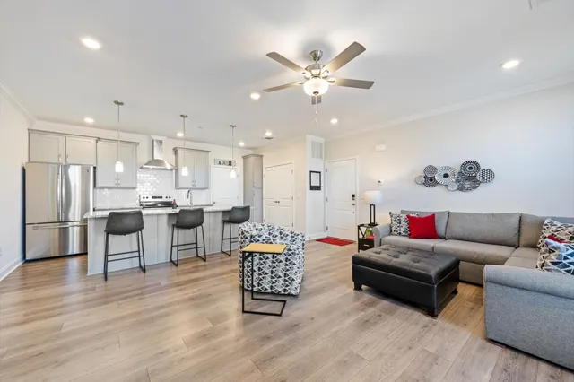 a kitchen with kitchen island a stove a table and chairs in it