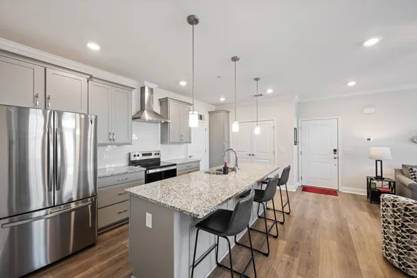 a kitchen with stainless steel appliances granite countertop a stove and a sink