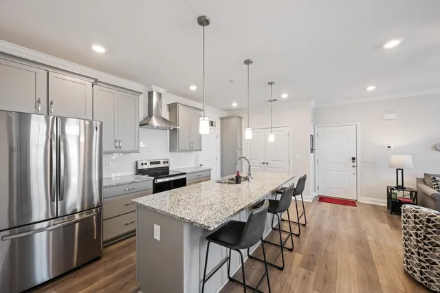 a kitchen with stainless steel appliances granite countertop a stove and a sink