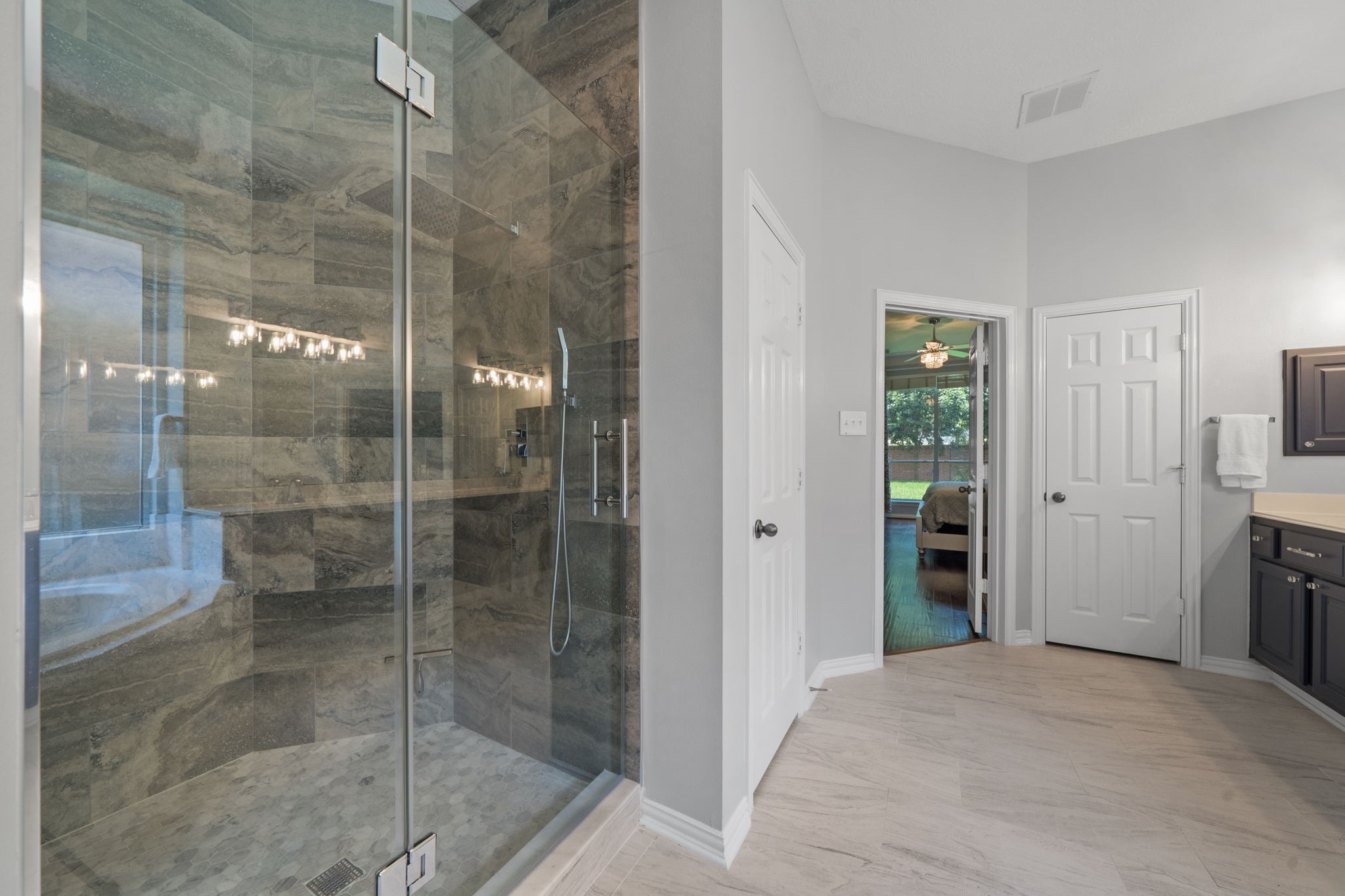 14718 Ramblebrook Humble, TX 77396 - Photo 14 of 38 The updated shower adds a clean, polished finish to the primary bath, giving the suite a more current and refined feel.