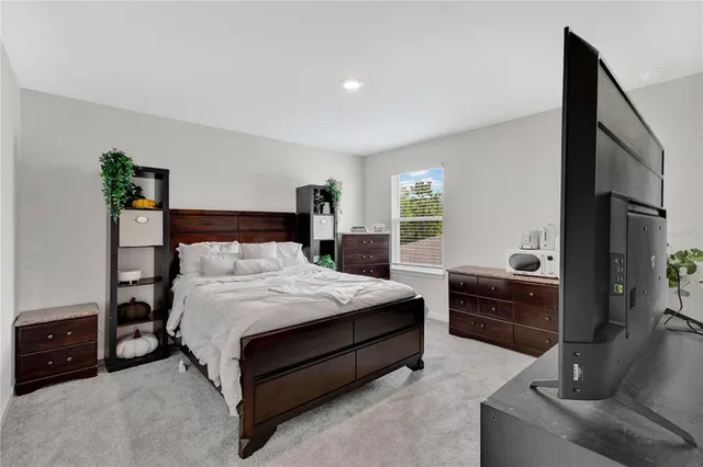 a bedroom with a bed and a dresser in it