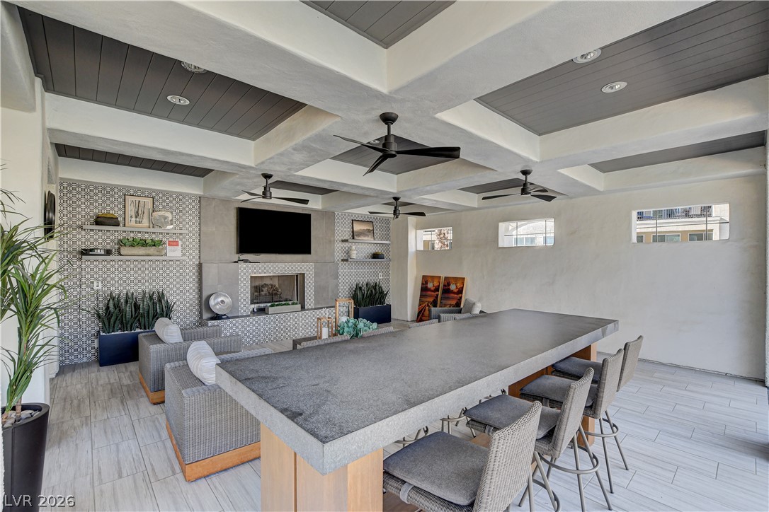 2555 Hampton Road, Unit 2207 Henderson, NV 89052 - Photo 57 of 74 An inviting community lounge with a large fireplace and ceiling fans, perfect for social gatherings.
