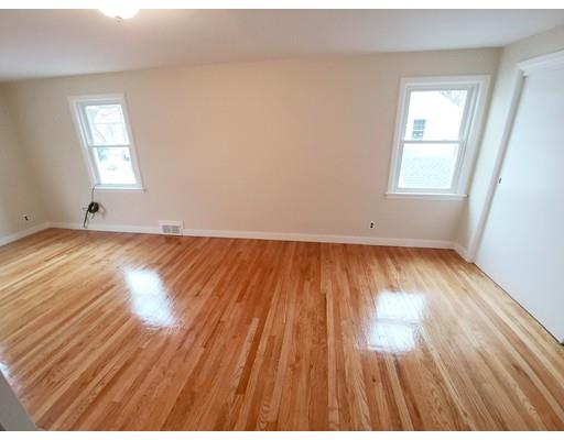 603 Allen Street Springfield, MA 01118 - Photo 11 of 12 an empty room with wooden floor and windows