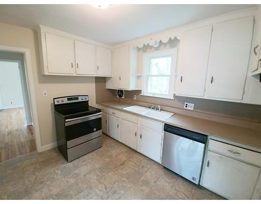 603 Allen Street Springfield, MA 01118 - Photo 4 of 12 a kitchen with granite countertop white cabinets and appliances