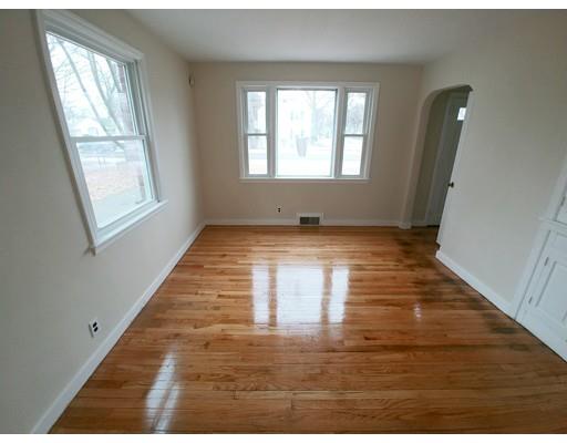 603 Allen Street Springfield, MA 01118 - Photo 5 of 12 an empty room with wooden floor and windows