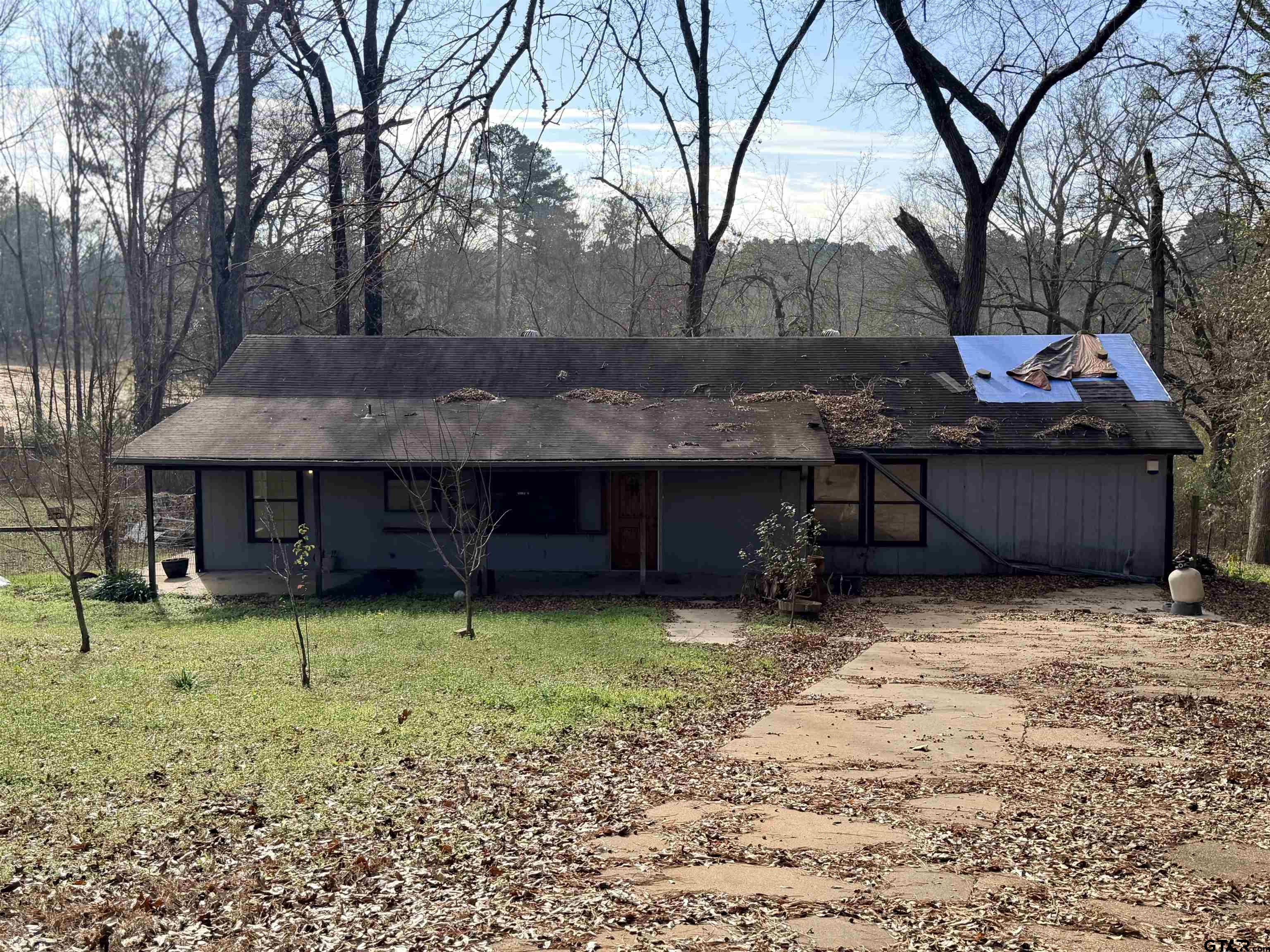 a backyard of a house with yard and barbeque oven