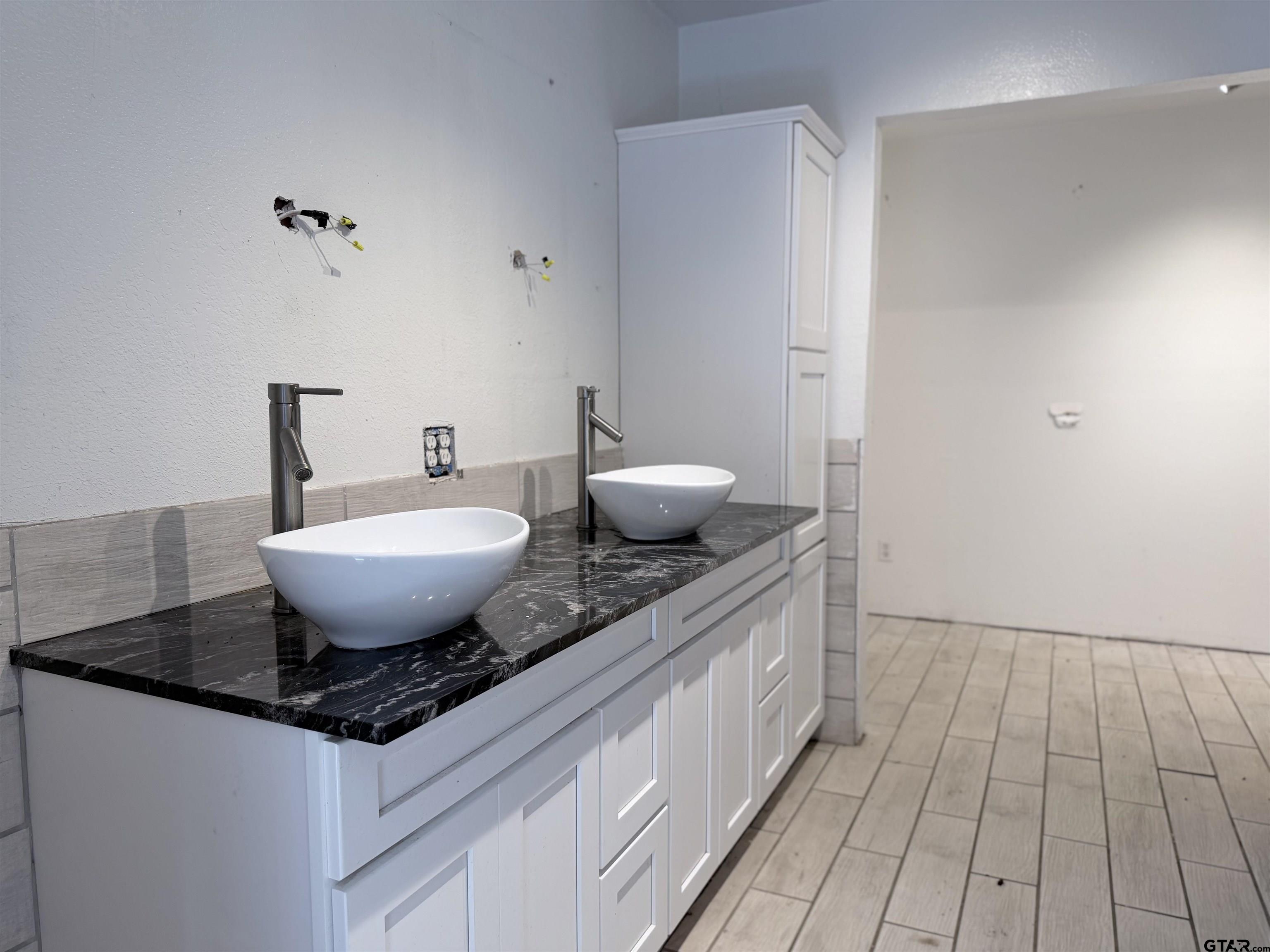 14946 County Road 220 Tyler, TX 75707 - Photo 27 of 41 a view of a bathroom with a sink and mirror