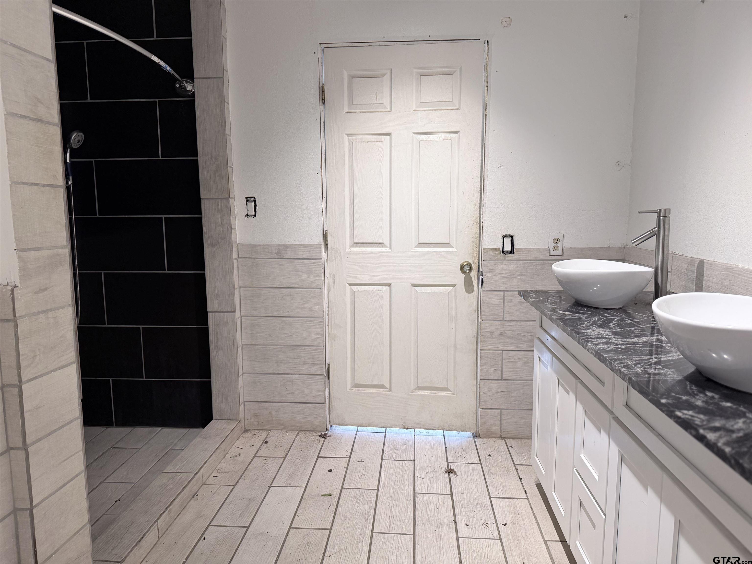 14946 County Road 220 Tyler, TX 75707 - Photo 28 of 41 a bathroom with a granite countertop sink a toilet and a shower