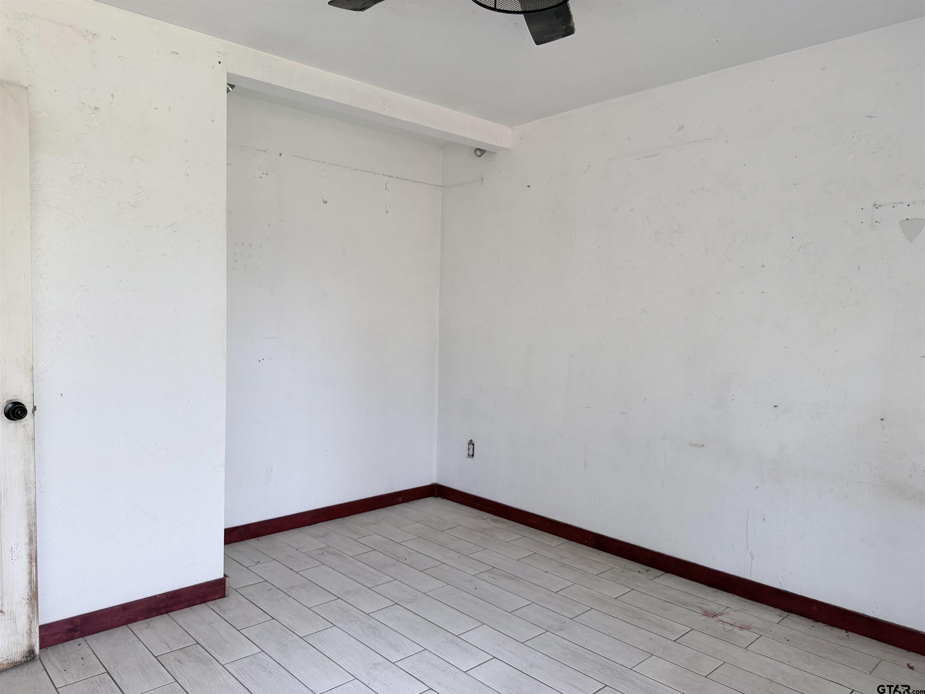 14946 County Road 220 Tyler, TX 75707 - Photo 9 of 41 a view of an empty room with wooden floor