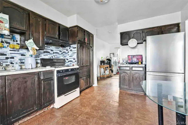 a kitchen with stainless steel appliances a refrigerator and a stove top oven