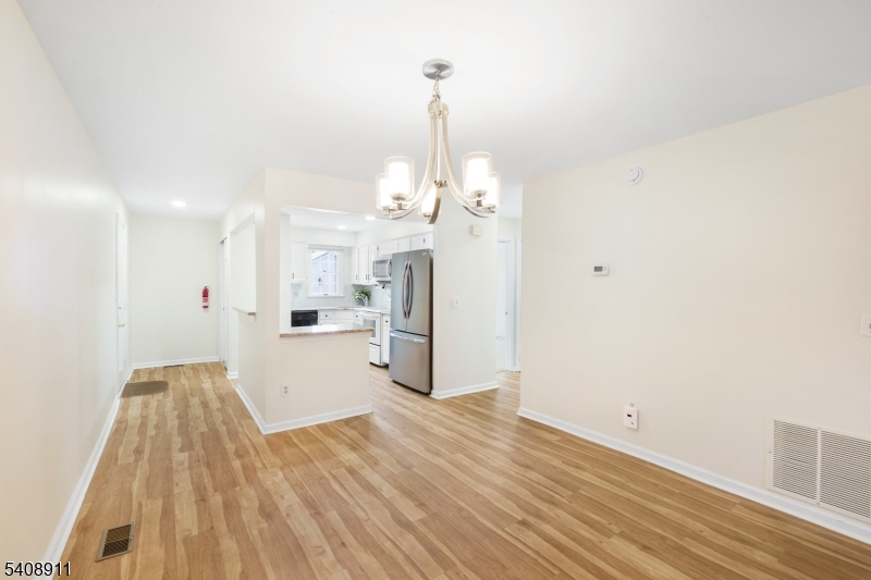 109 Alexandria Way Bernards, NJ 07920 - Photo 5 of 16 a view of a kitchen with wooden floor and a refrigerator