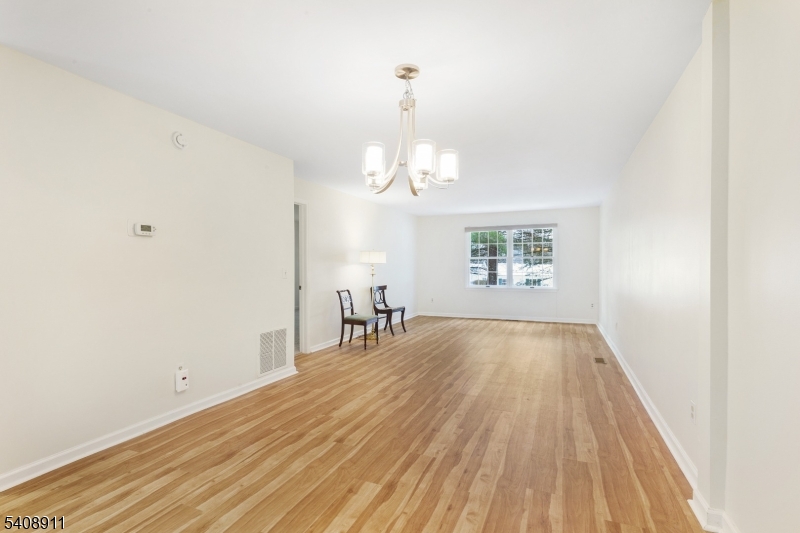 109 Alexandria Way Bernards, NJ 07920 - Photo 7 of 16 wooden floor in an empty room with a window