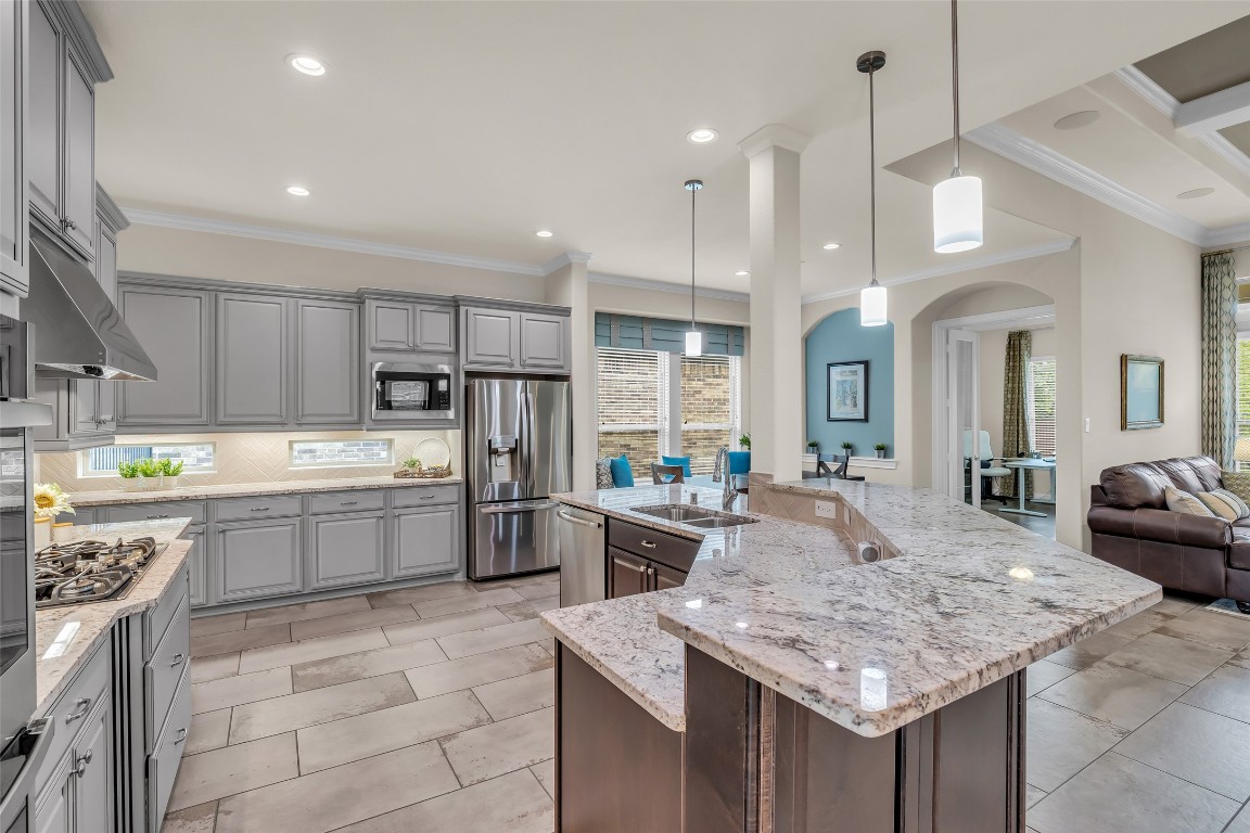 4060 Windsor Chase Drive Spring, TX 77386 - Photo 11 of 40 a kitchen with kitchen island granite countertop a sink counter top space appliances and cabinets