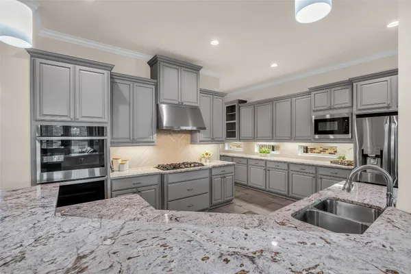 a kitchen with a sink stove and refrigerator