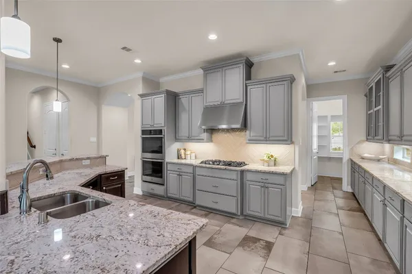 a kitchen with stainless steel appliances granite countertop a sink counter space cabinets and a large window