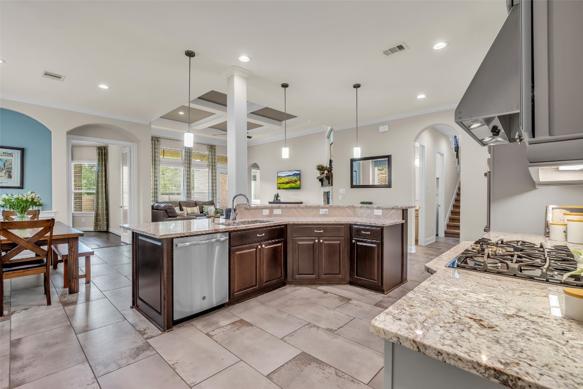 4060 Windsor Chase Drive Spring, TX 77386 - Photo 16 of 40 a large kitchen with stainless steel appliances kitchen island granite countertop a large stove a refrigerator a sink dishwasher with a dining table and chairs