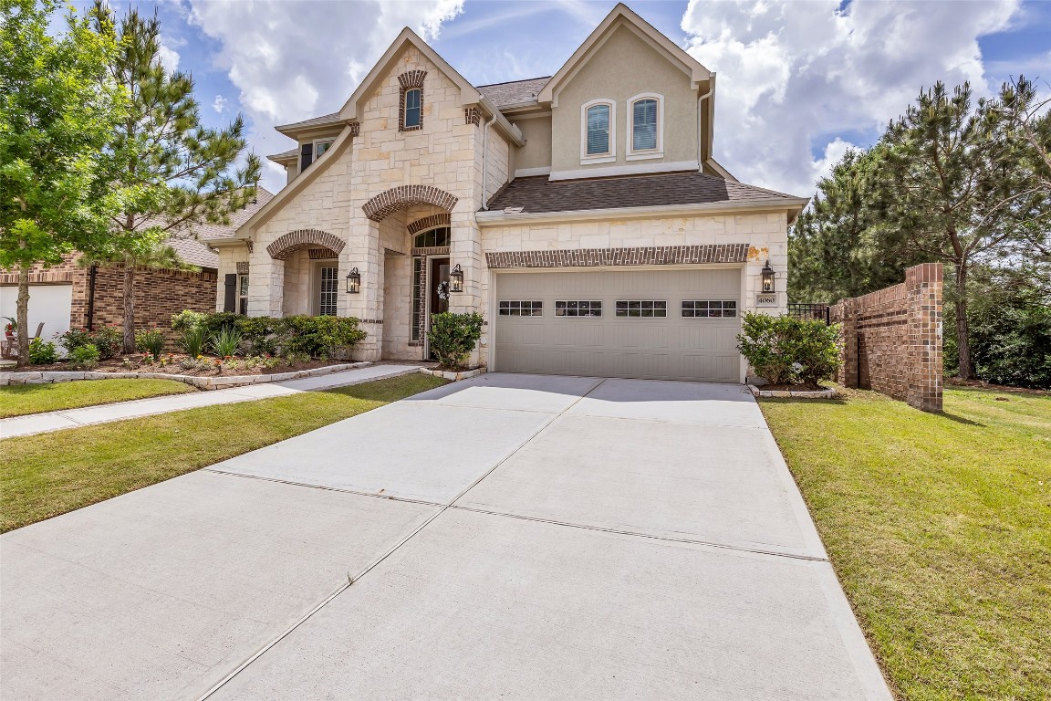 4060 Windsor Chase Drive Spring, TX 77386 - Photo 2 of 40 a front view of a house with a yard and garage