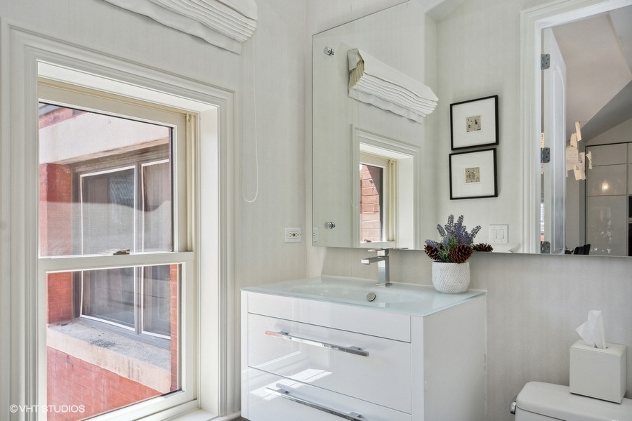 1919 South Prairie Avenue, Unit 5 Chicago, IL 60616 - Photo 11 of 19 a bathroom with a sink and a mirror