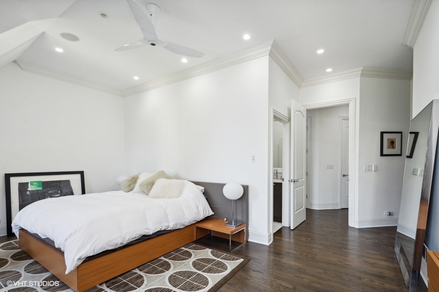 1919 South Prairie Avenue, Unit 5 Chicago, IL 60616 - Photo 14 of 19 a bedroom with a bed and wooden floor