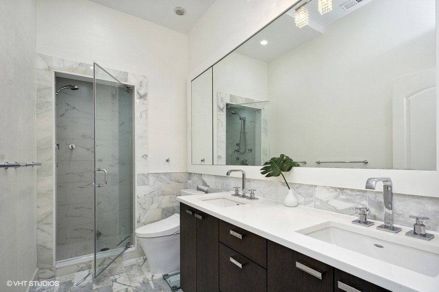 1919 South Prairie Avenue, Unit 5 Chicago, IL 60616 - Photo 16 of 19 a bathroom with a double vanity sink mirror and shower