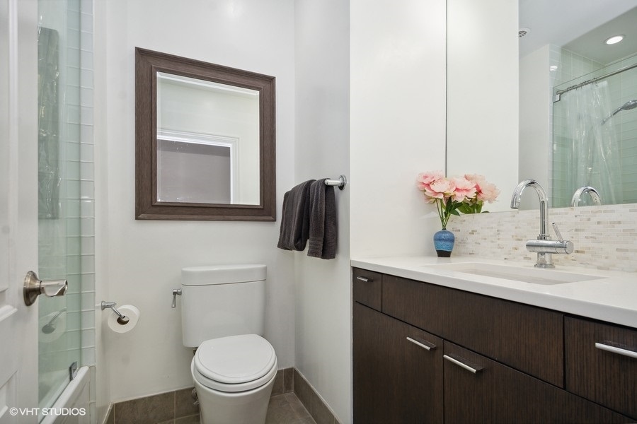 1919 South Prairie Avenue, Unit 5 Chicago, IL 60616 - Photo 18 of 19 a bathroom with a toilet sink and mirror