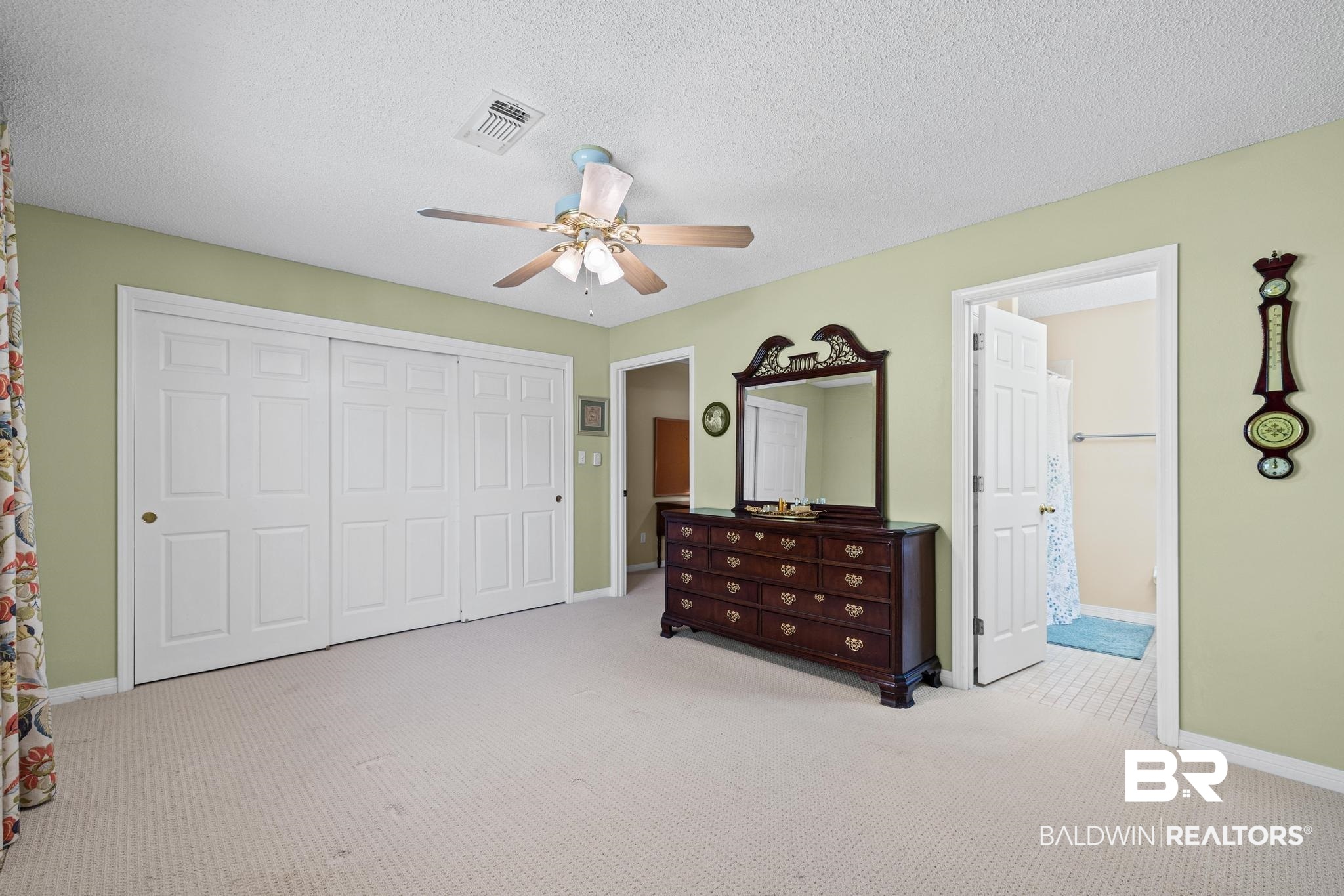 2881 Eslava Circle Lillian, AL 36549 - Photo 13 of 58 Bedroom featuring light carpet, a closet, a ceiling fan, and a textured ceiling