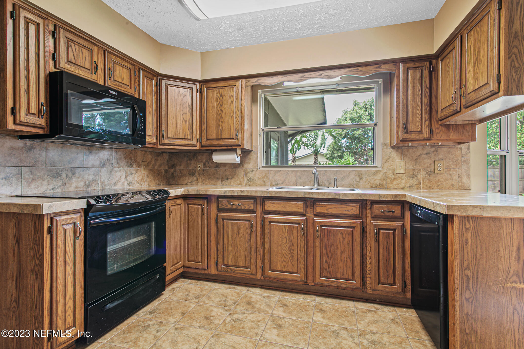 71 Vanderford Road East Orange Park, FL 32073 - Photo 12 of 52 a kitchen with stainless steel appliances granite countertop a stove a sink and a microwave