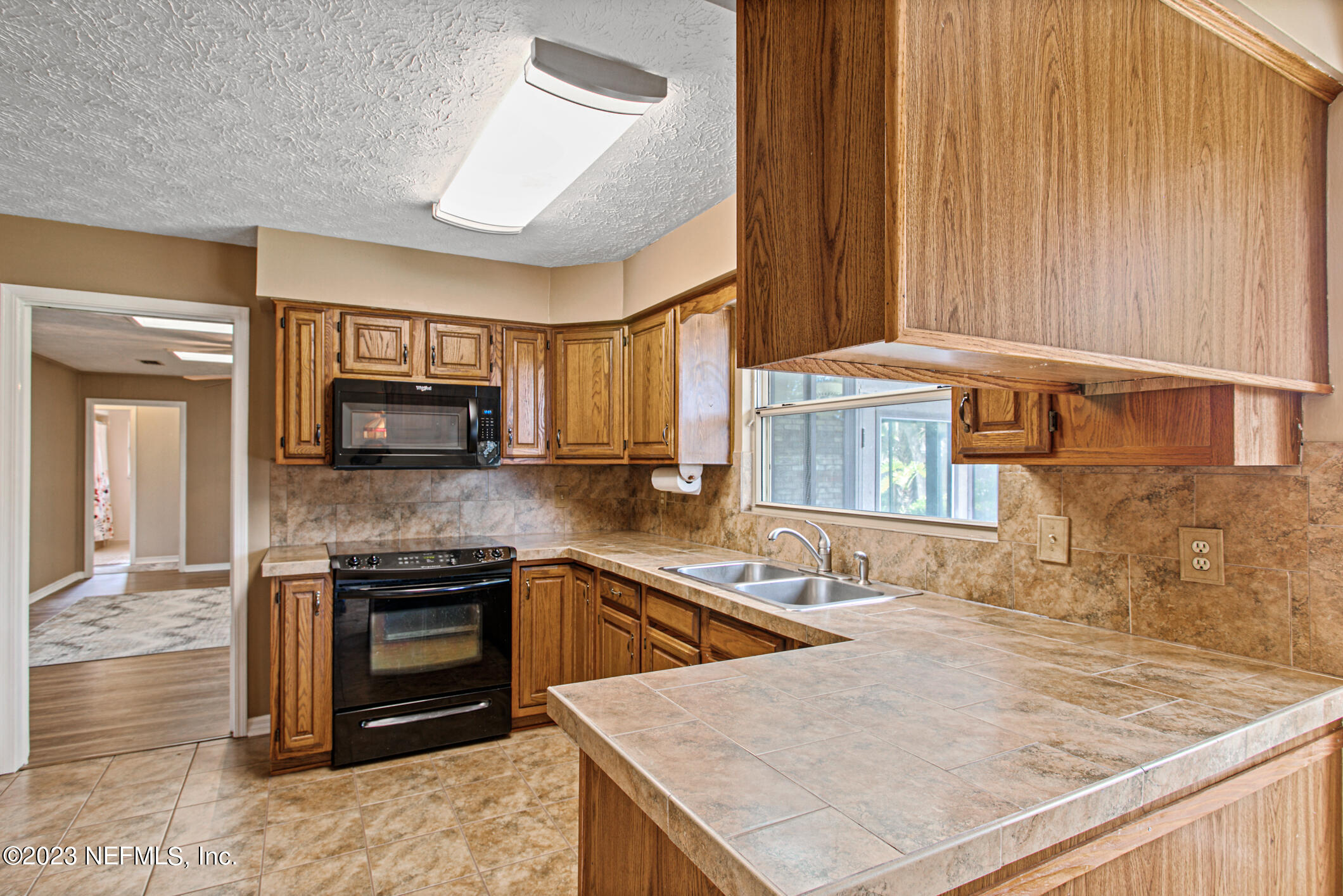 71 Vanderford Road East Orange Park, FL 32073 - Photo 14 of 52 a kitchen with stainless steel appliances granite countertop a sink and a stove