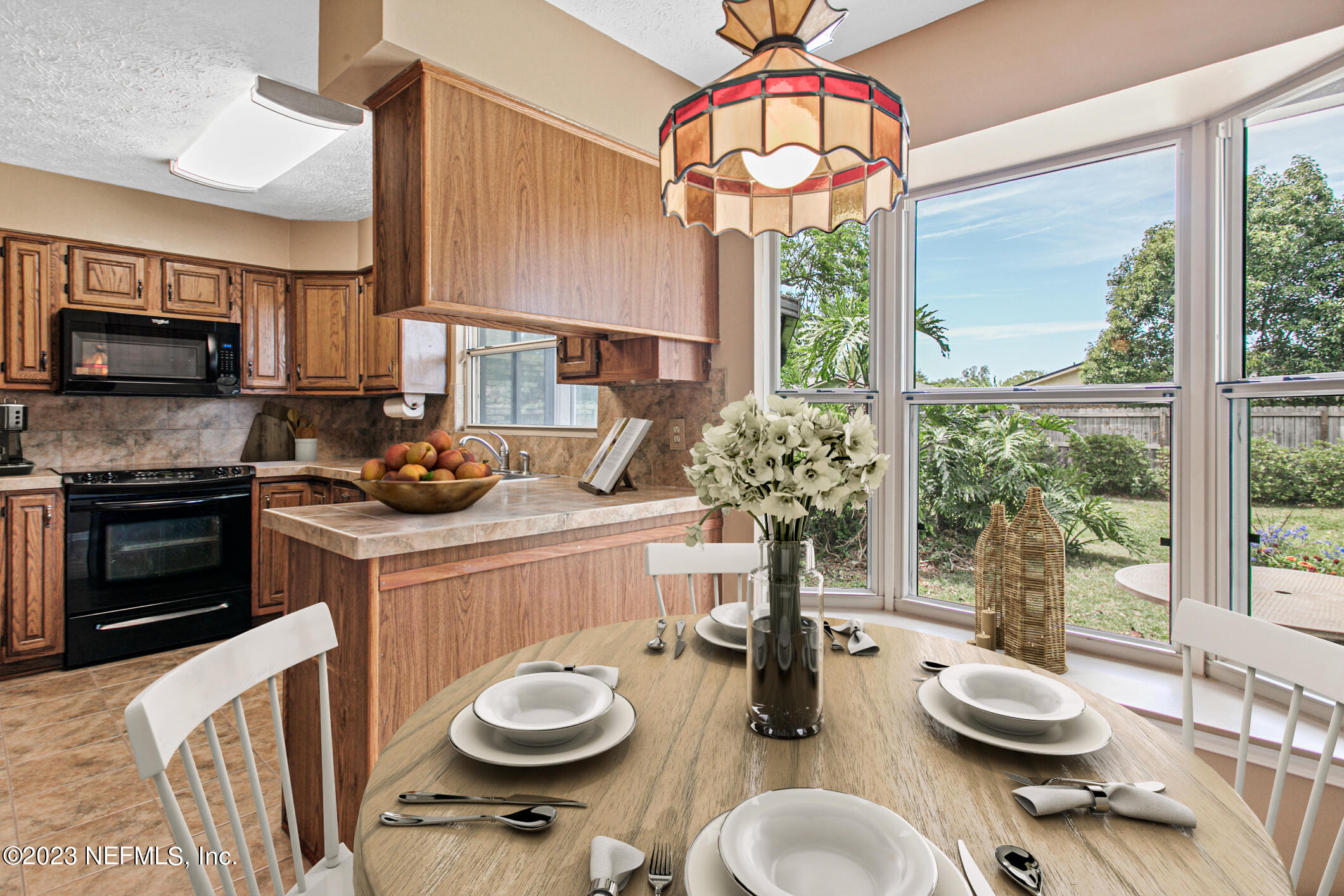 71 Vanderford Road East Orange Park, FL 32073 - Photo 18 of 52 a kitchen with a sink a stove and a chandelier
