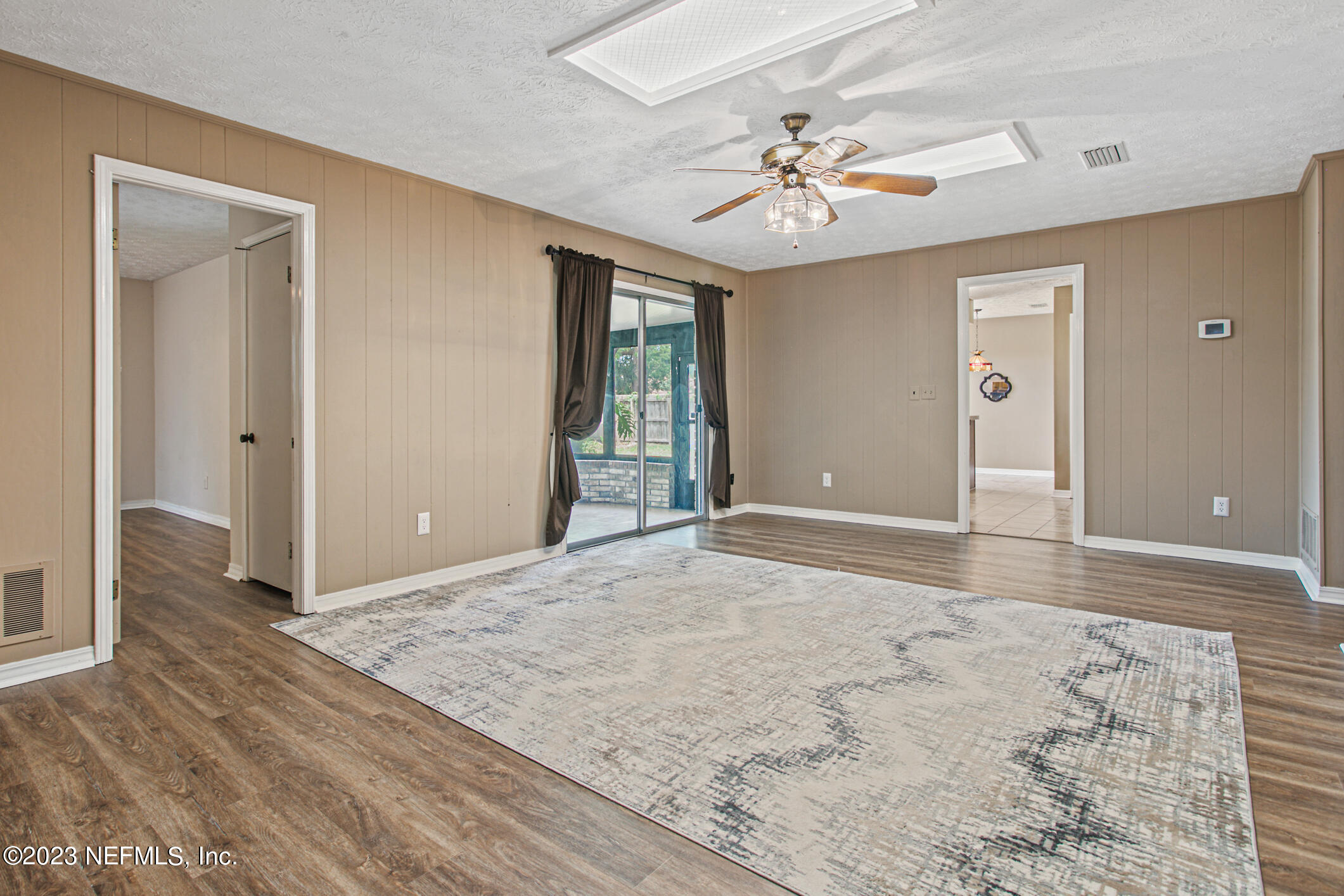 71 Vanderford Road East Orange Park, FL 32073 - Photo 21 of 52 wooden floor in an empty room with a window