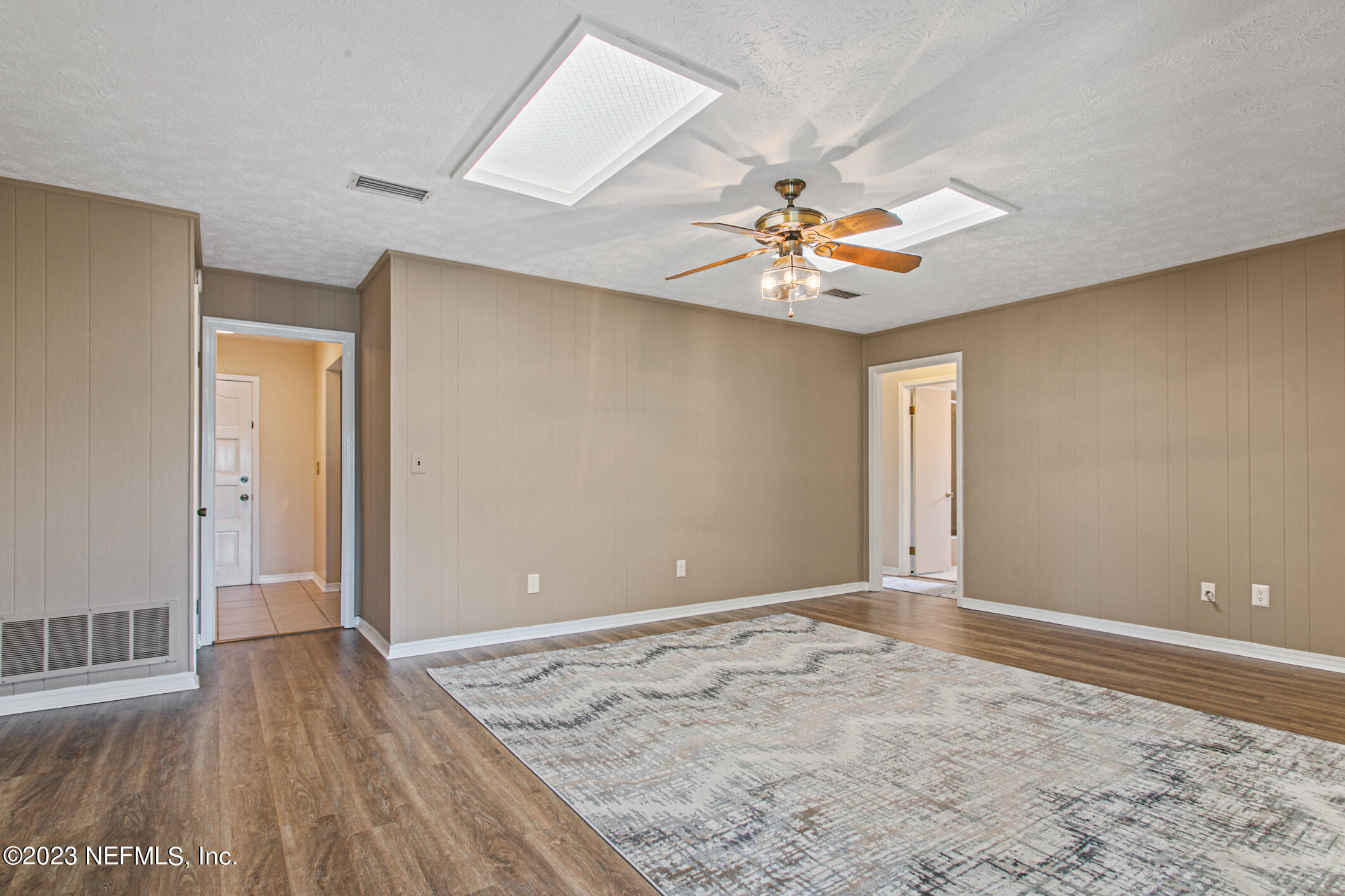 71 Vanderford Road East Orange Park, FL 32073 - Photo 23 of 52 a view of an empty room and window with wooden floor