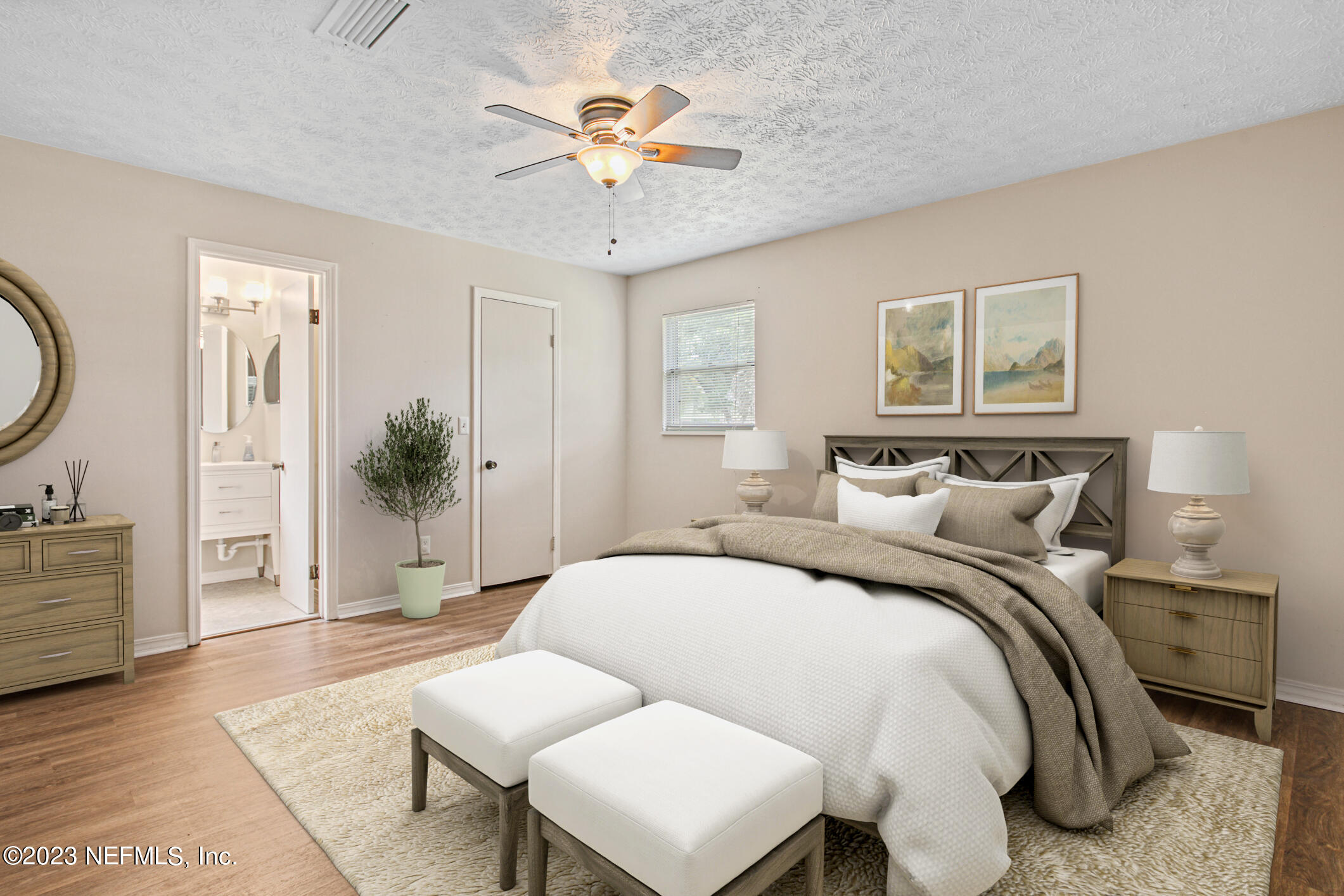 71 Vanderford Road East Orange Park, FL 32073 - Photo 25 of 52 a spacious bedroom with a bed a couch and potted plant on the dresser