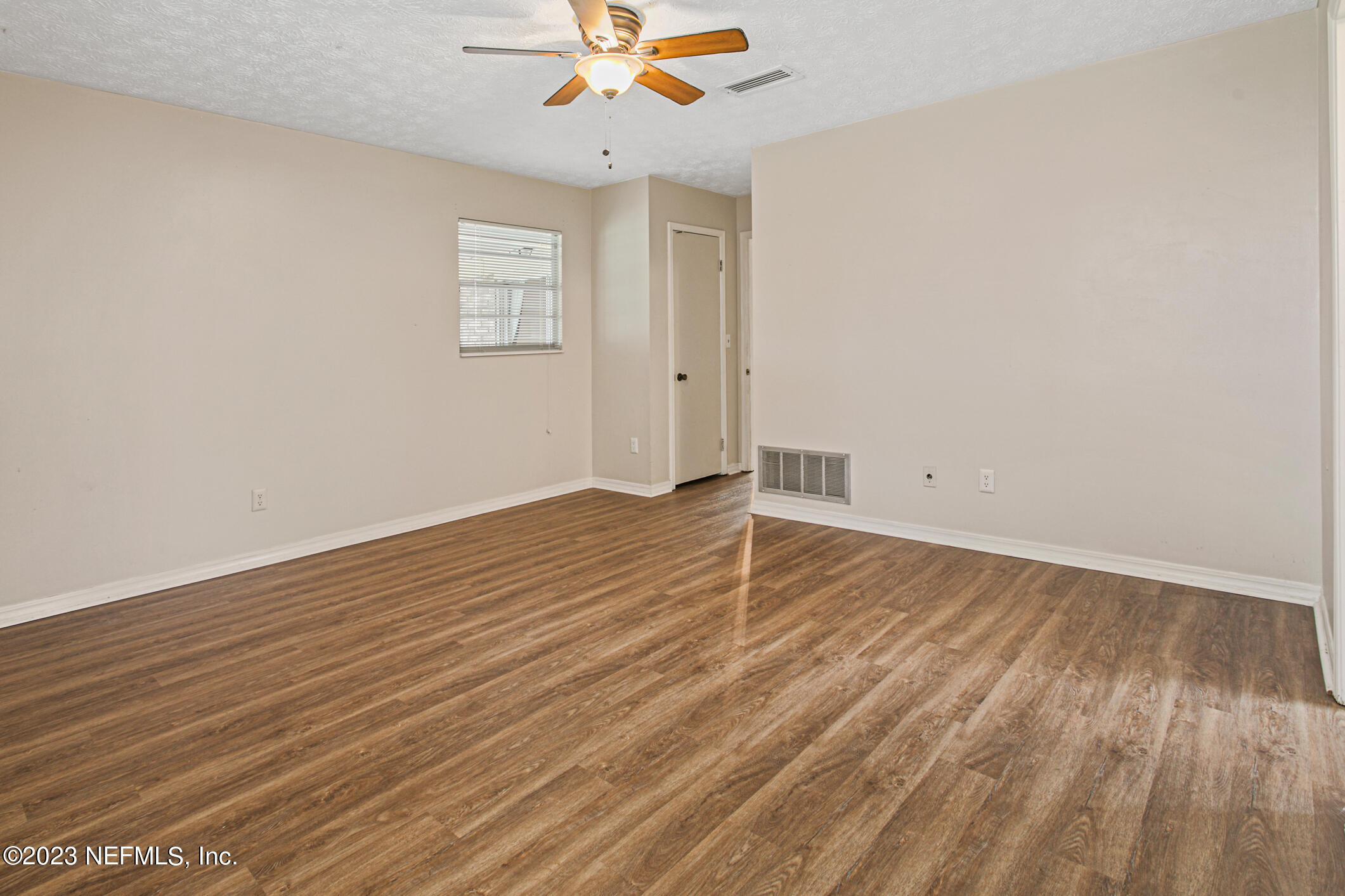 71 Vanderford Road East Orange Park, FL 32073 - Photo 26 of 52 an empty room with wooden floor and windows