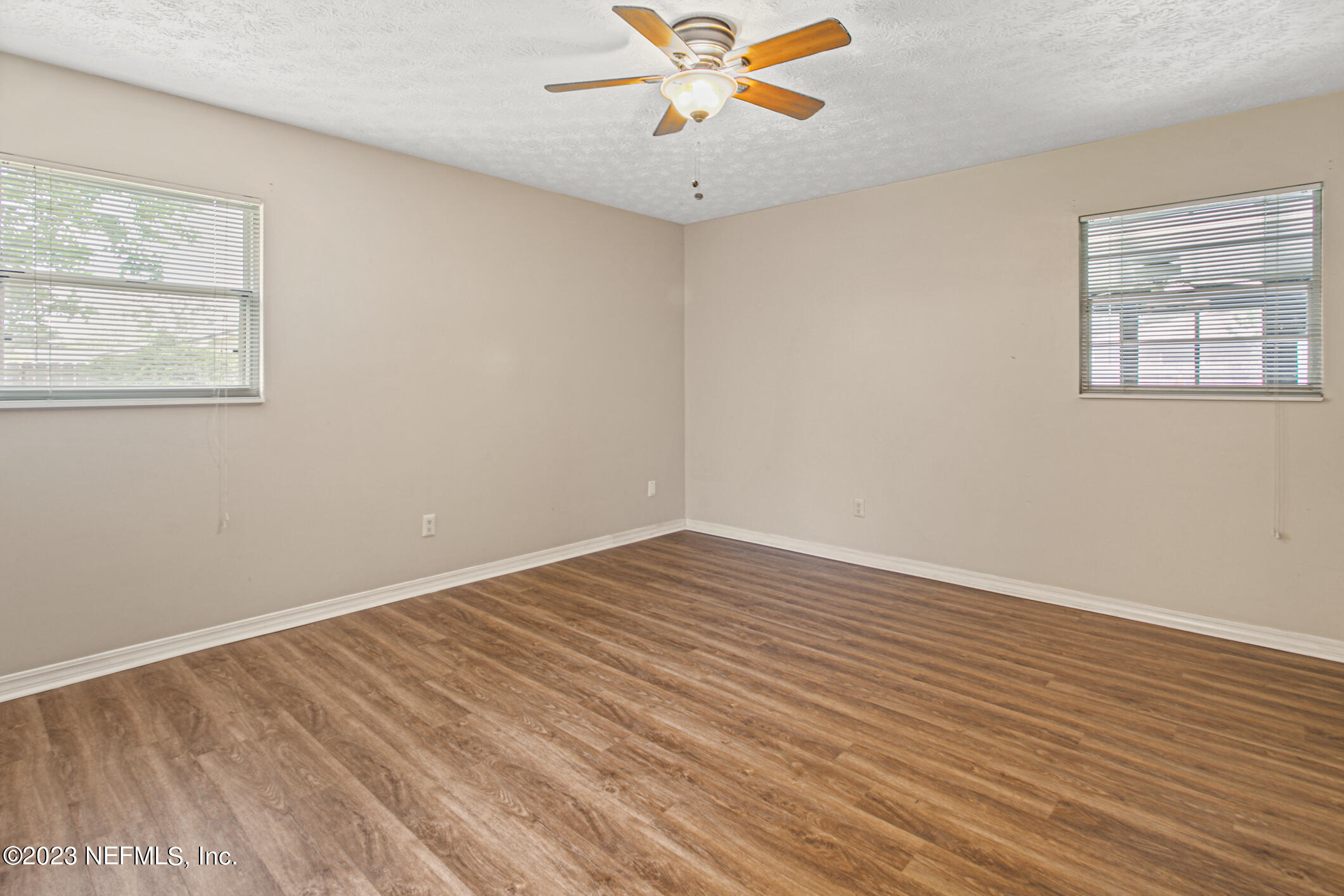 71 Vanderford Road East Orange Park, FL 32073 - Photo 27 of 52 a view of an empty room with wooden floor and a window