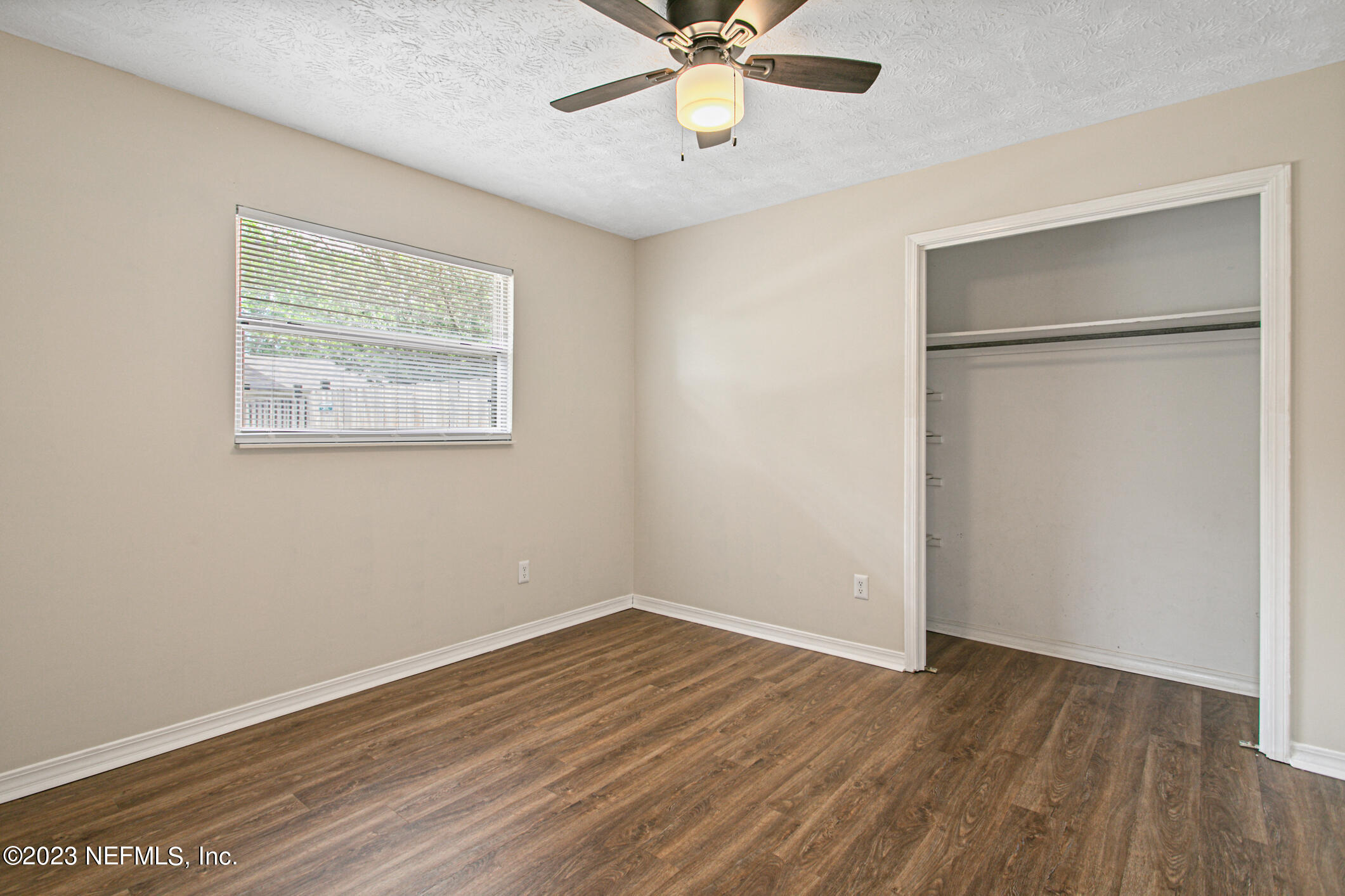 71 Vanderford Road East Orange Park, FL 32073 - Photo 29 of 52 a view of an empty room with wooden floor and a ceiling fan