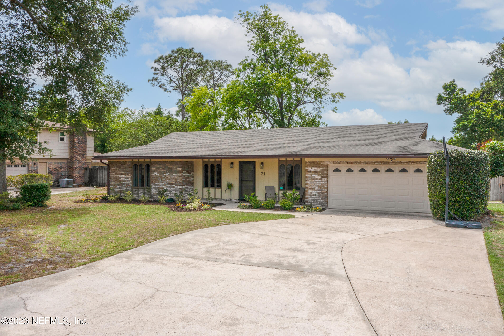 71 Vanderford Road East Orange Park, FL 32073 - Photo 3 of 52 a front view of a house with a garden and trees