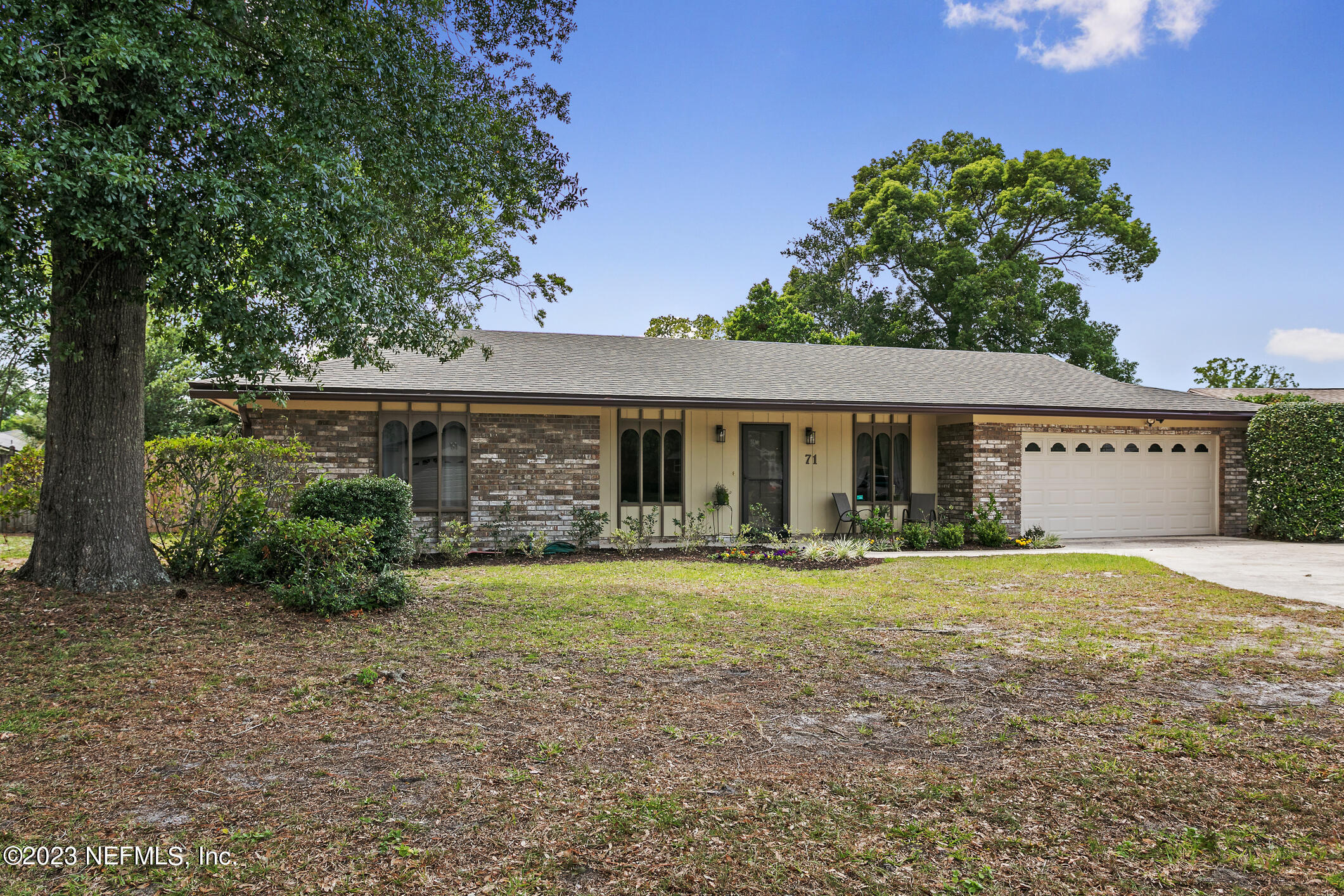 71 Vanderford Road East Orange Park, FL 32073 - Photo 51 of 52 a front view of a house with a yard and porch