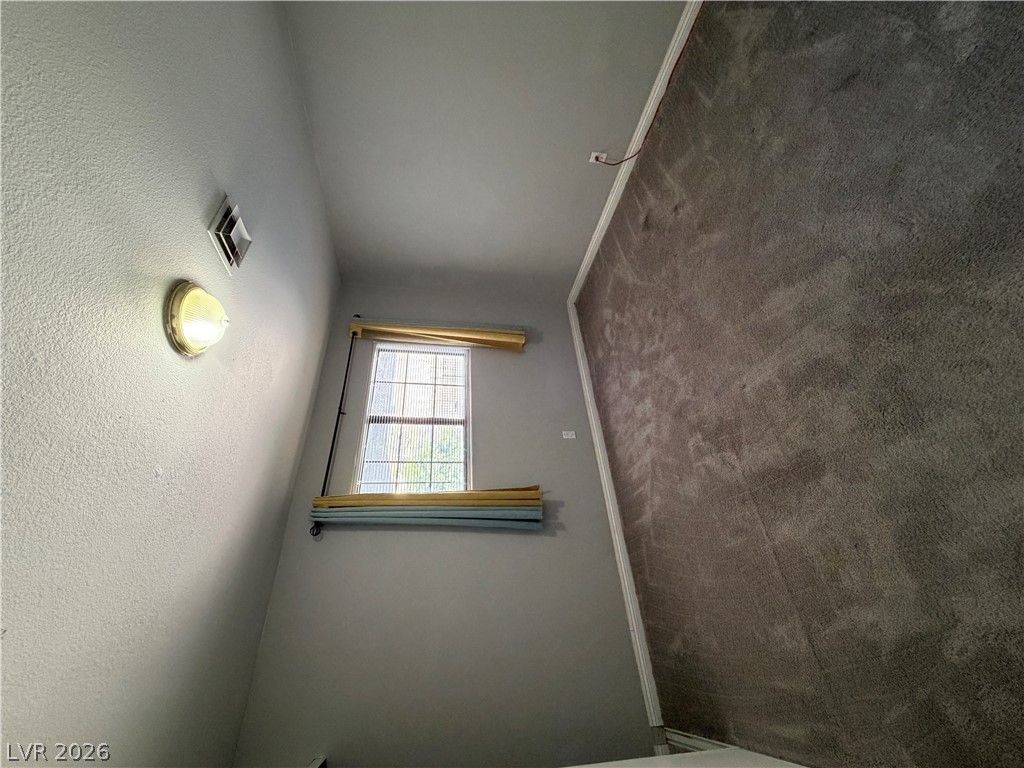 2820 South Sandhill Road, Unit A Las Vegas, NV 89121 - Photo 19 of 26 A well-lit interior space featuring a single window and soft carpeting.
