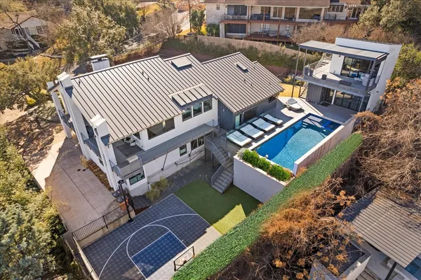 an aerial view of a house with a yard and balcony