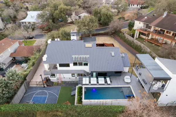 an aerial view of residential houses with outdoor space and parking