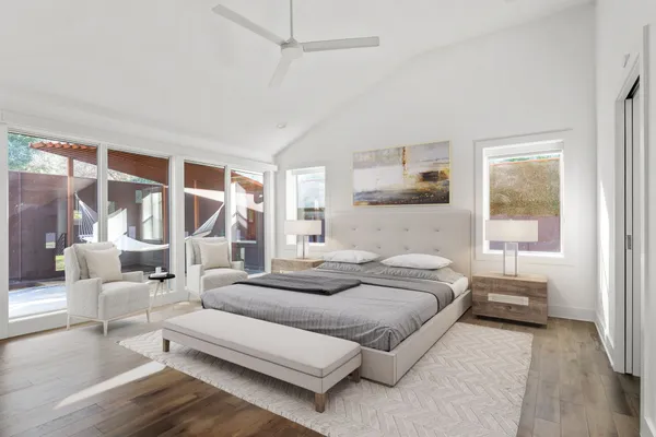 a bedroom with furniture and a large window