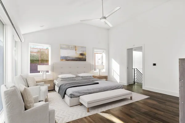 a bedroom with a bed and a chandelier