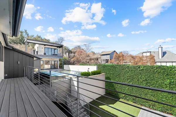 a view of a balcony with two chairs and wooden fence