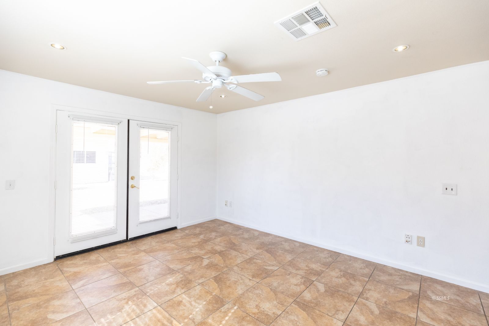 247 North Norma Street Ridgecrest, CA 93555 - Photo 10 of 31 an empty room with a ceiling fan and a window