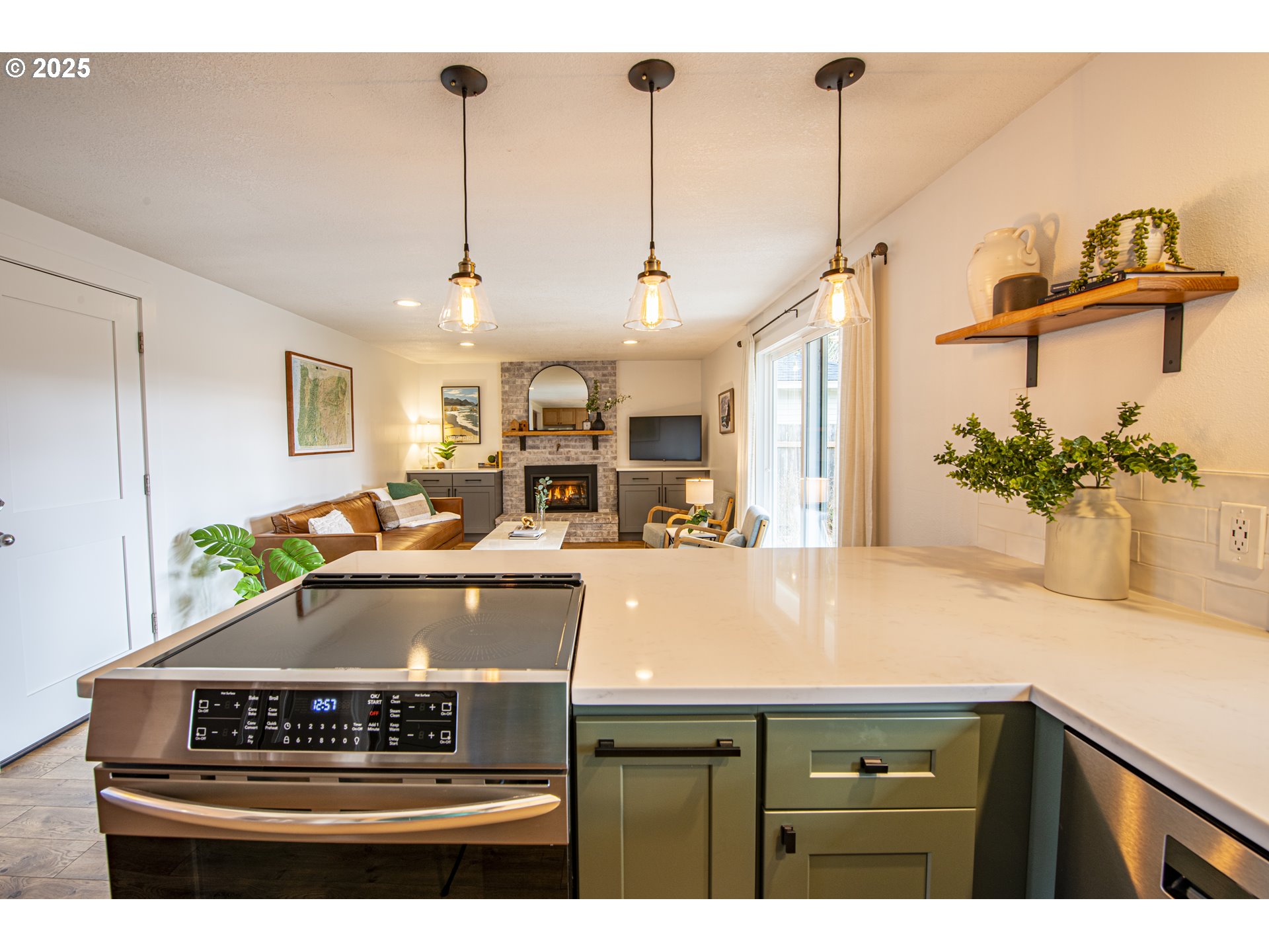 3052 Kentwood Drive Eugene, OR 97401 - Photo 12 of 43 a view of a kitchen with kitchen island stainless steel appliances a sink stove and refrigerator