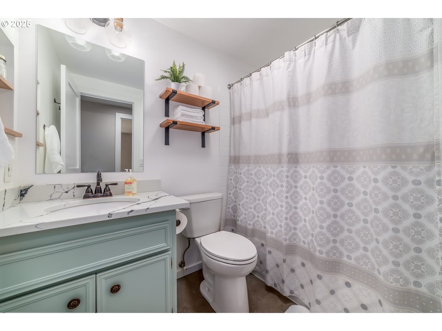 3052 Kentwood Drive Eugene, OR 97401 - Photo 23 of 43 a bathroom with a granite countertop sink a toilet and a mirror