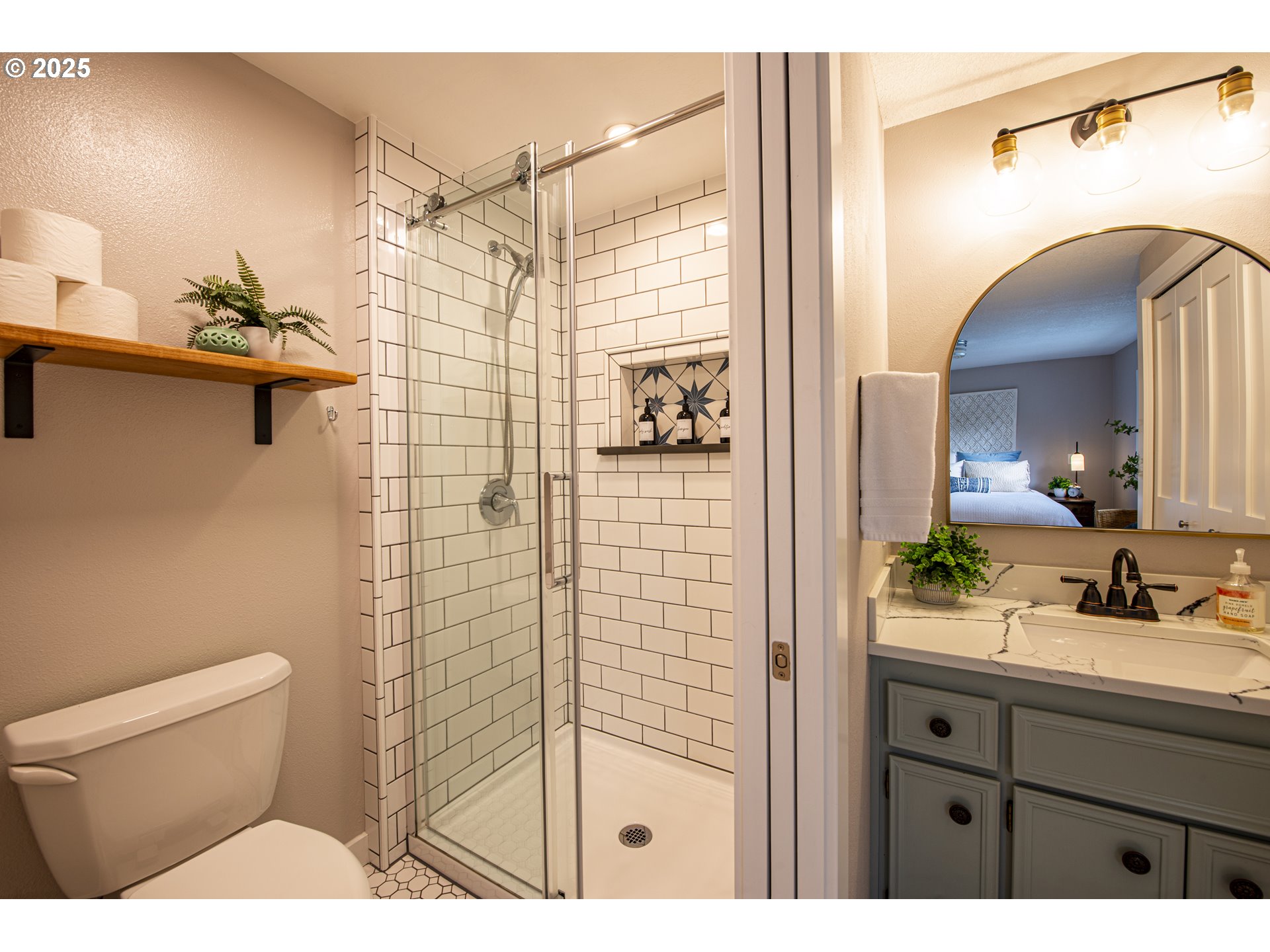 3052 Kentwood Drive Eugene, OR 97401 - Photo 30 of 43 a bathroom with a sink a toilet a mirror and shower