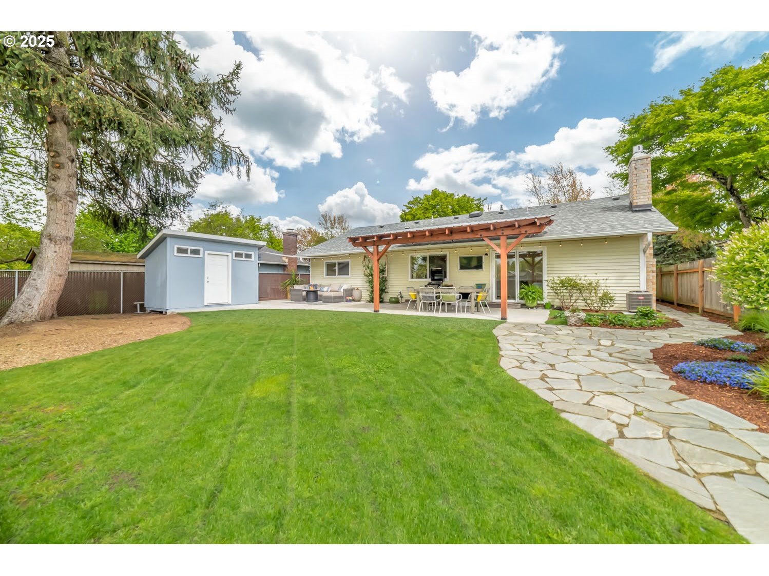 3052 Kentwood Drive Eugene, OR 97401 - Photo 38 of 43 a front view of a house with a yard table and chairs