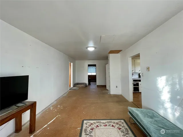 a view of a room with furniture and a ceiling fan